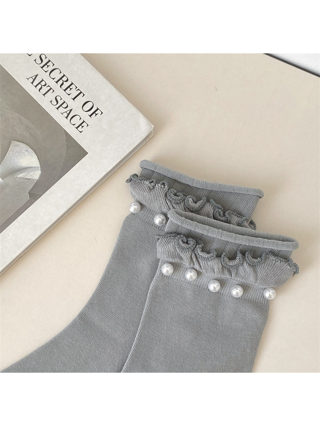 Close-up of the scalloped ruffled cuff and white bead-like accents