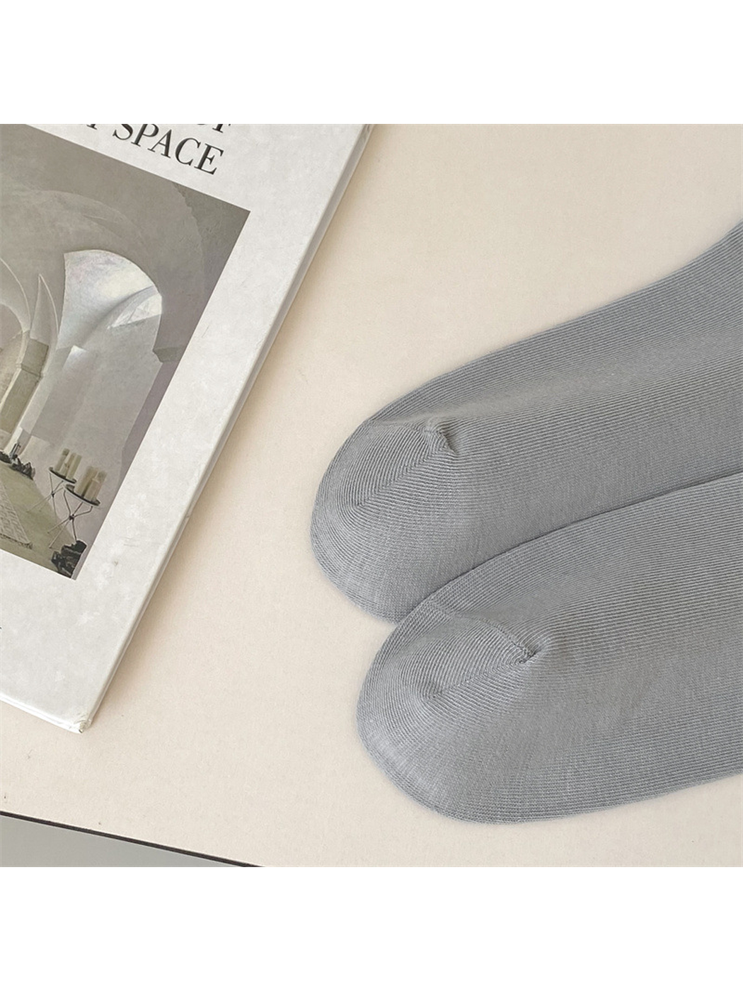 Close-up of the closed toe seams on light gray socks