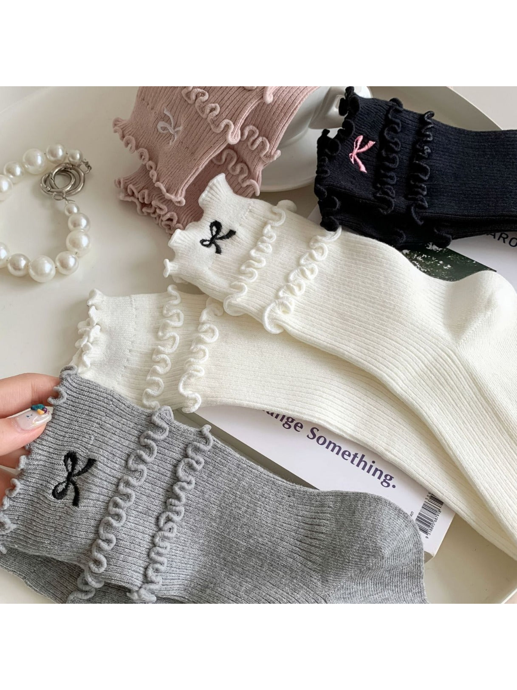 Close-up of the embroidered bow, ribbing and layered ruffle bands