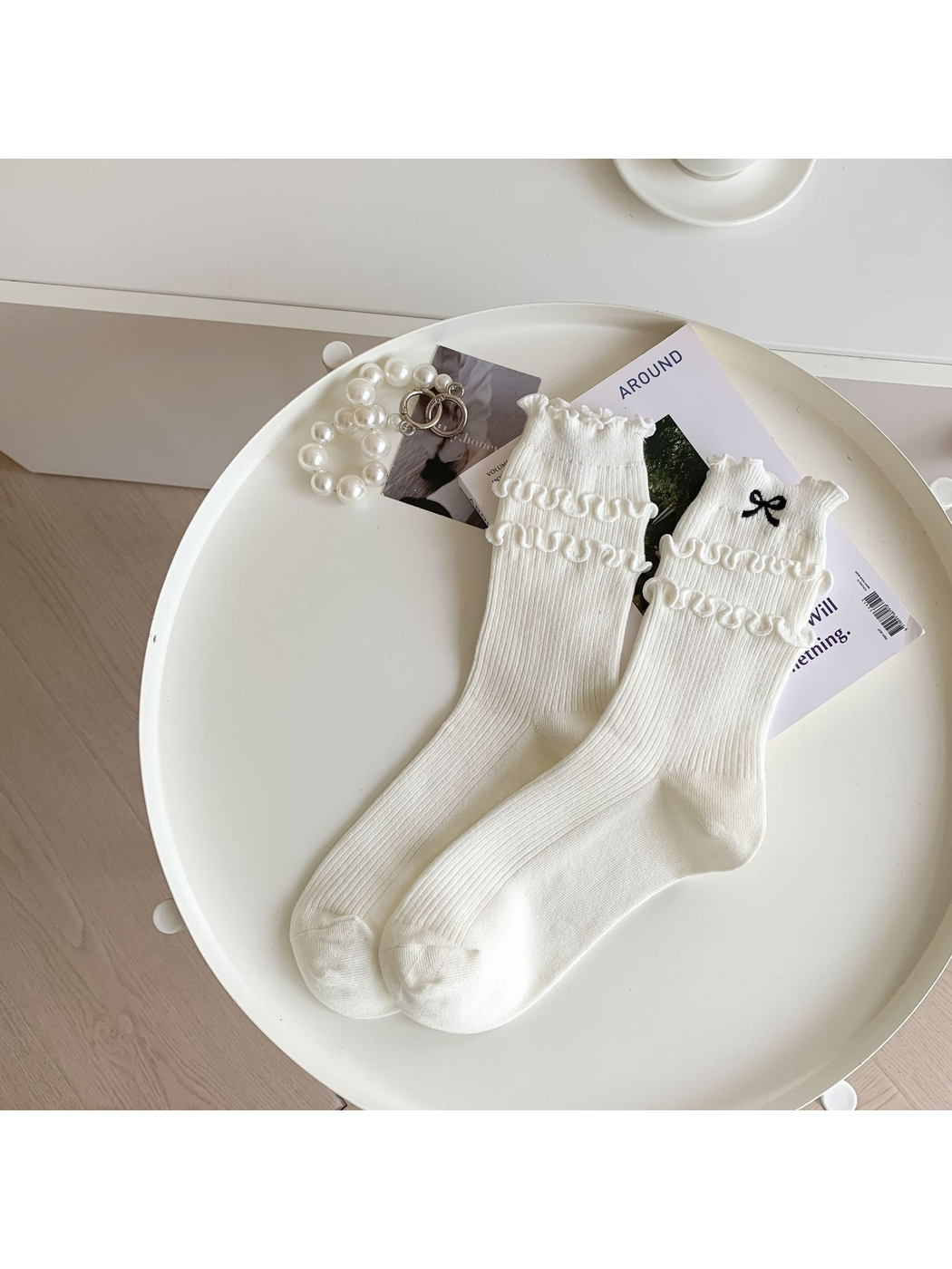 Ivory ruffled crew socks with black embroidered bow