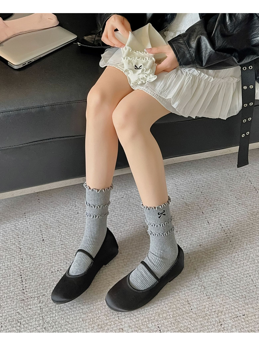 Heather gray ruffled bow socks worn with black strap shoes