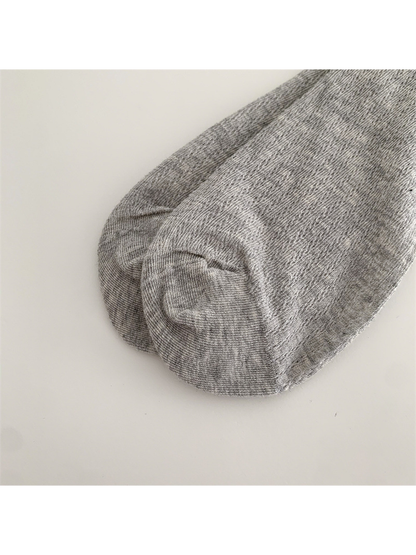 Close-up of the heather gray sock's rounded toe seam