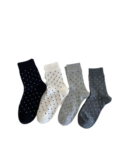 Four color variations of polka-dot crew socks displayed together
