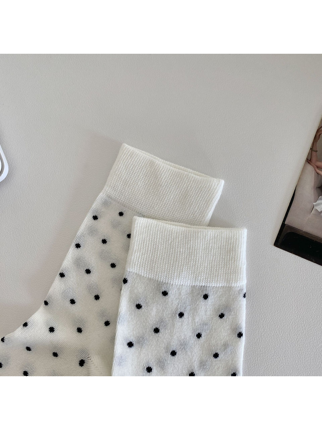 Close-up of the white socks' ribbed cuffs and polka-dot pattern