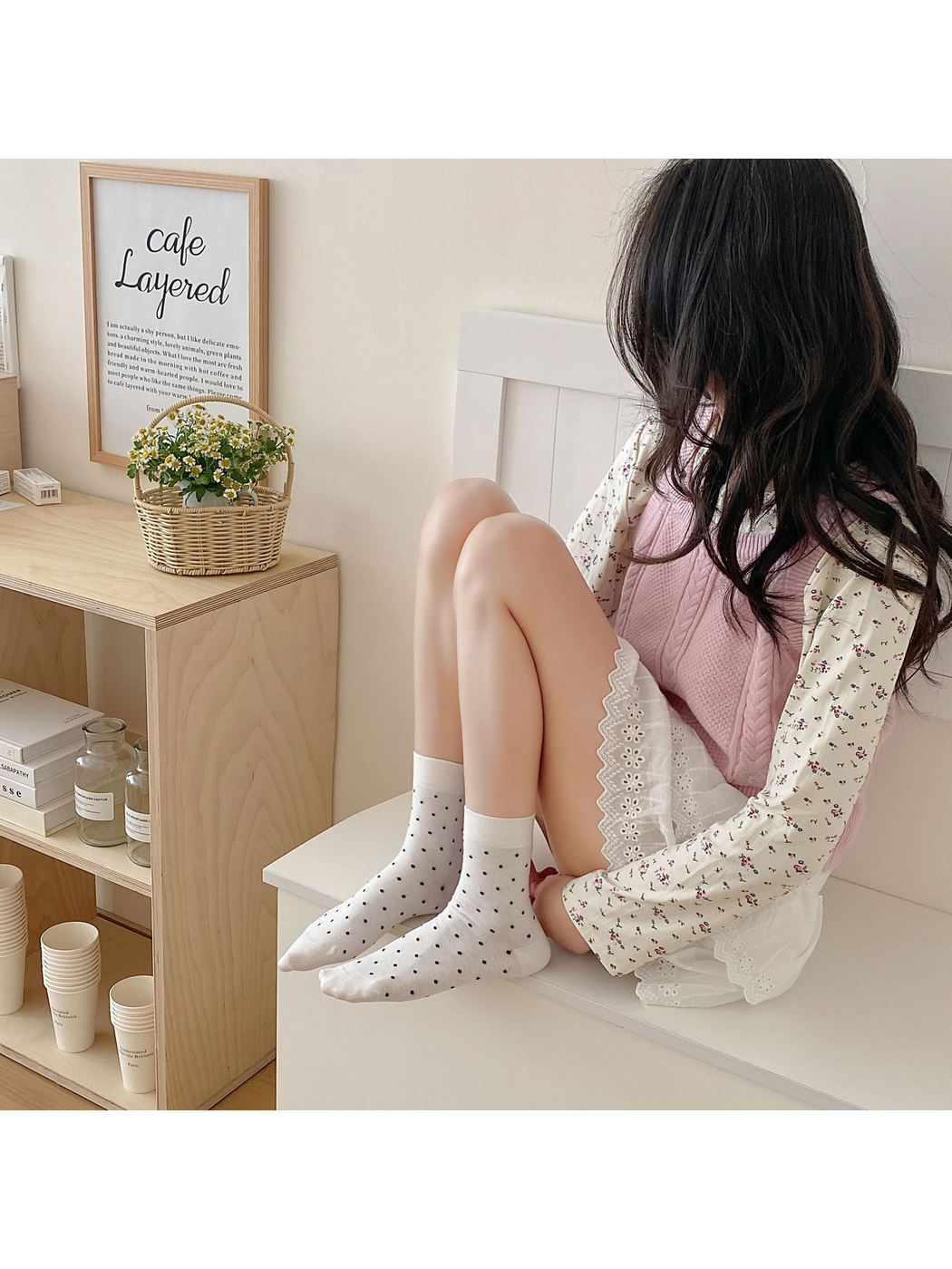 White polka-dot crew socks worn in a seated lifestyle setting