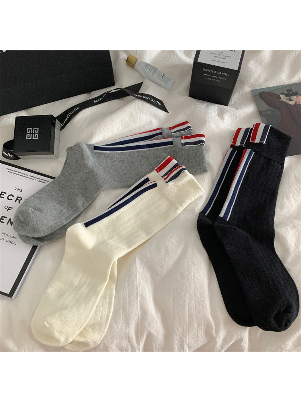 Black, ivory and gray striped crew socks arranged together