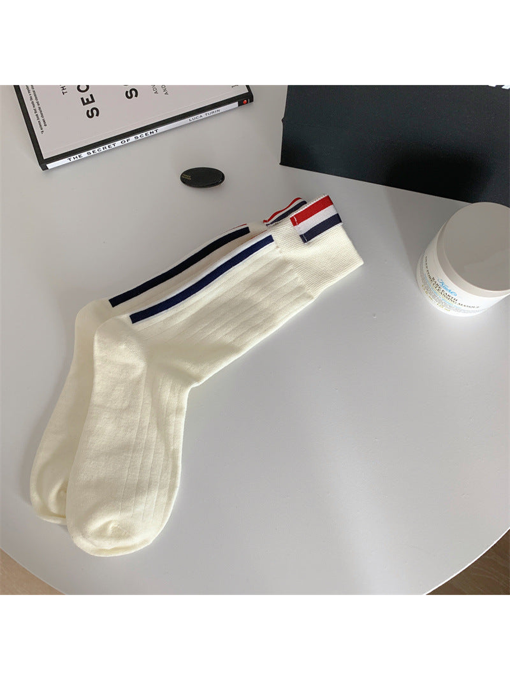 Ivory crew socks with navy side stripes and striped cuff tabs