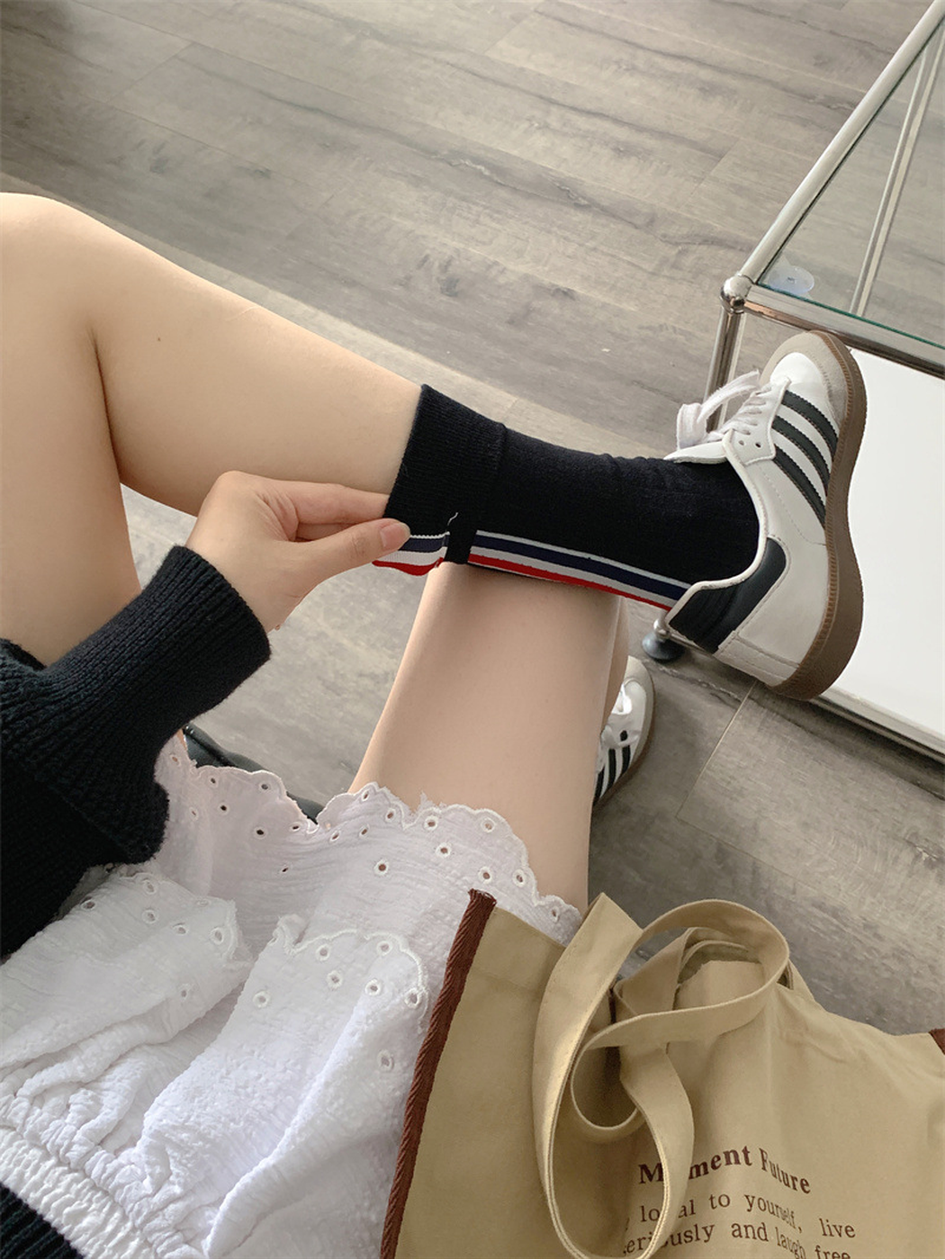Black striped crew sock worn with a white sneaker