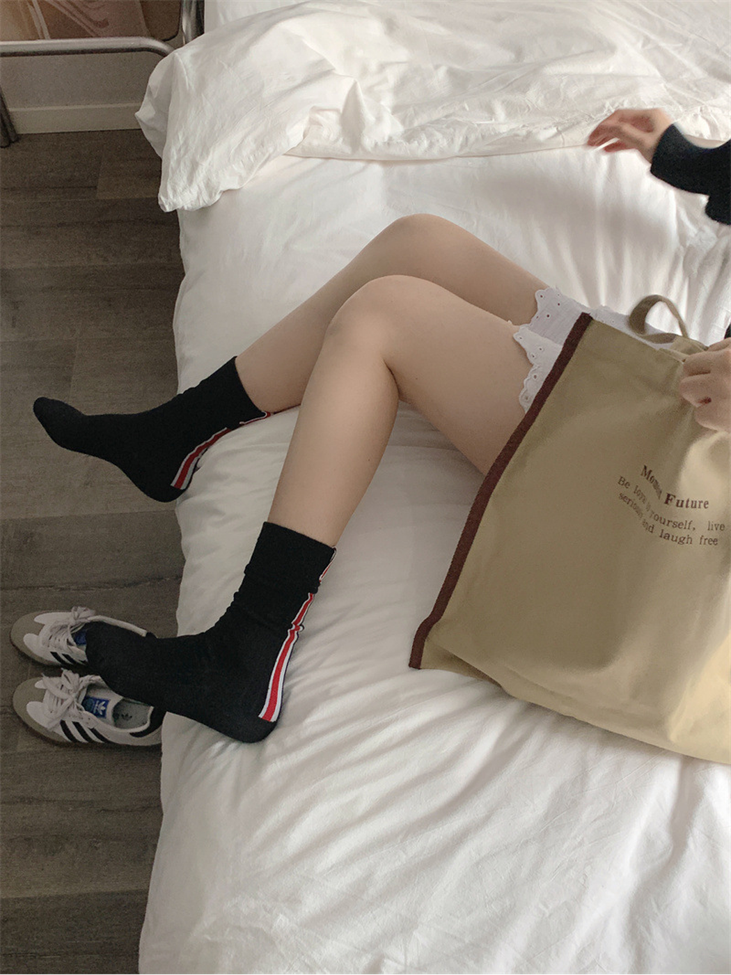 Black crew socks worn without shoes, showing the striped outer sides