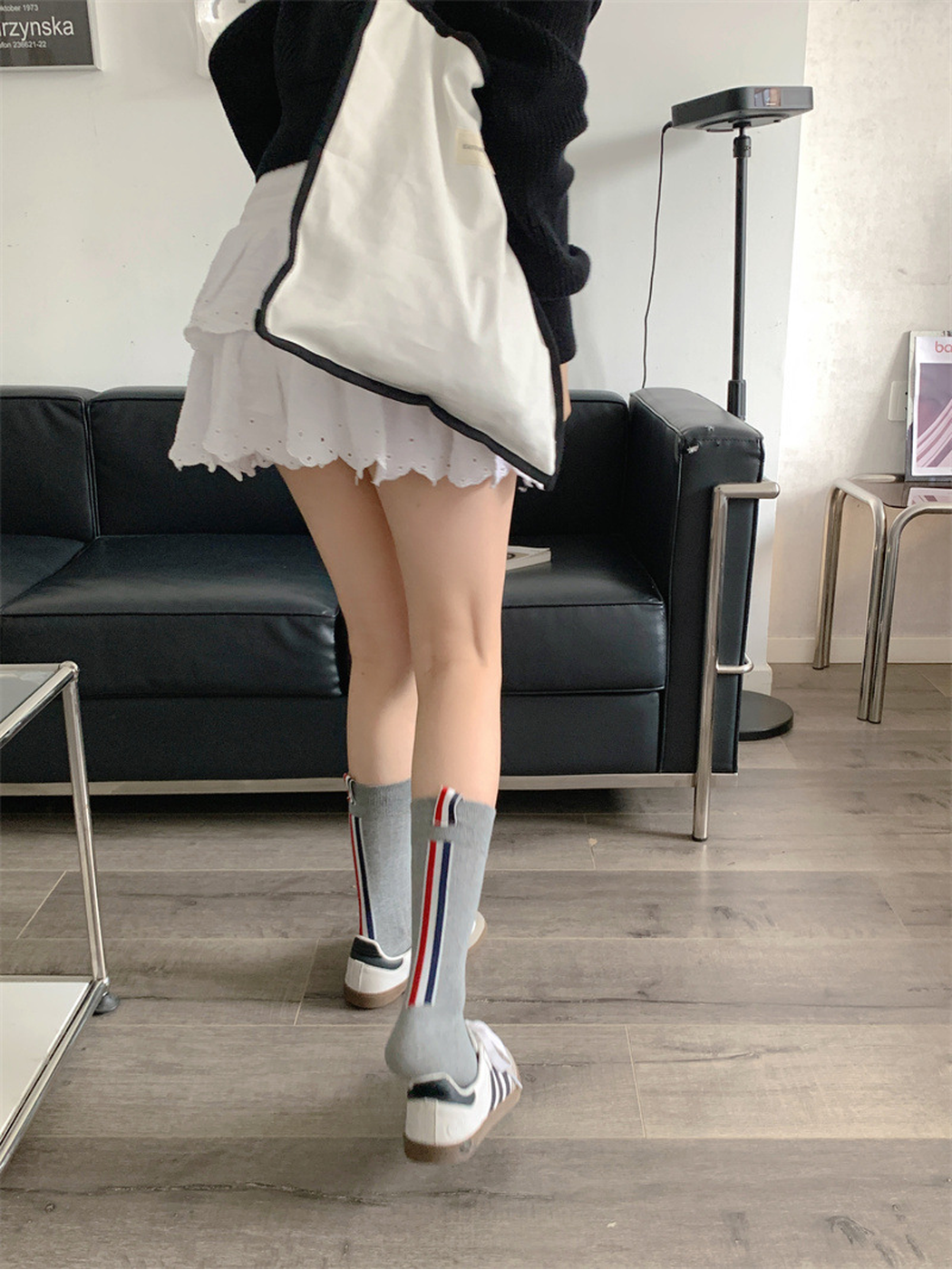 Gray crew socks from the back, showing vertical red, white and navy stripes