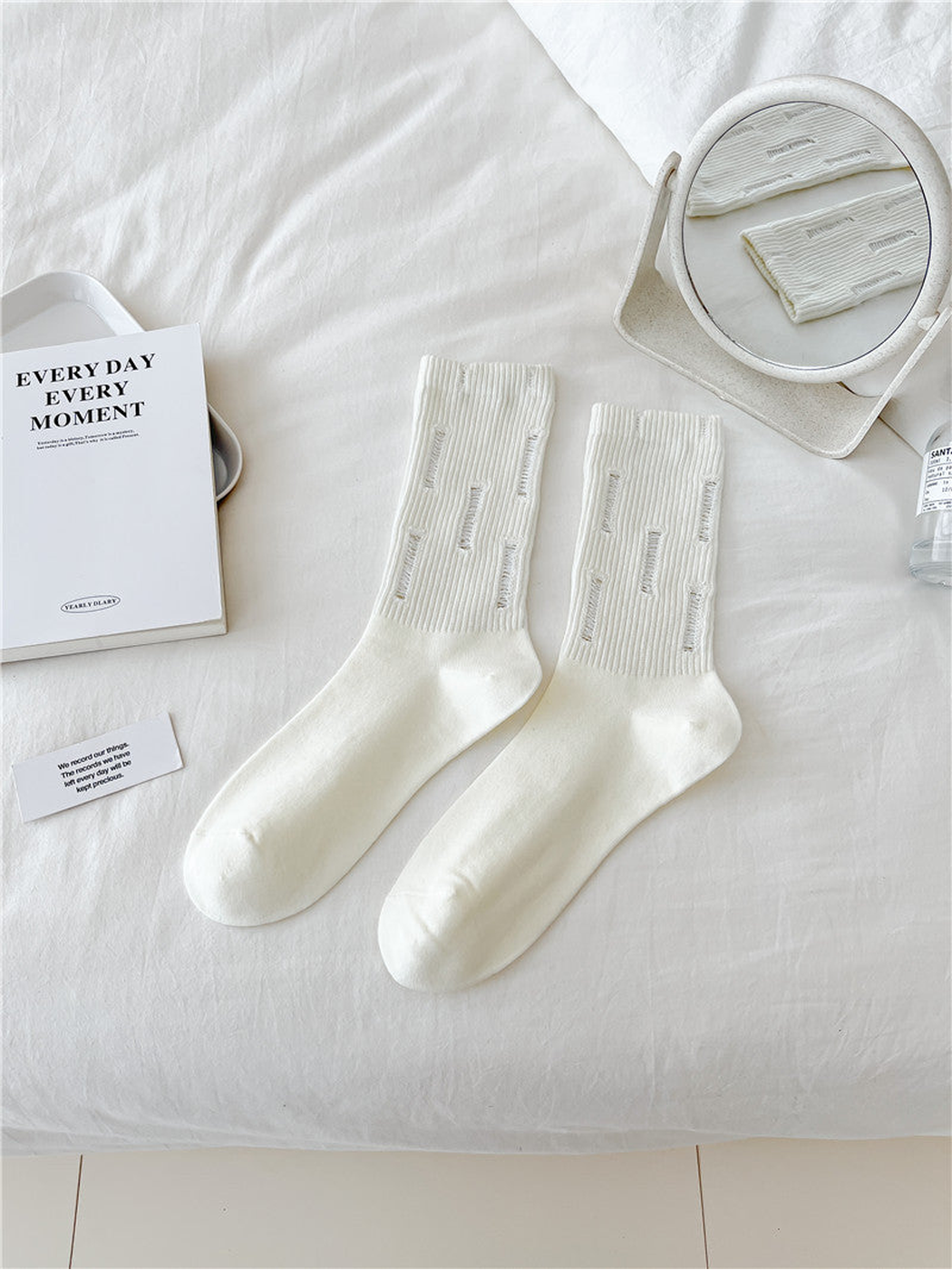Ivory distressed ribbed crew socks, flat lay