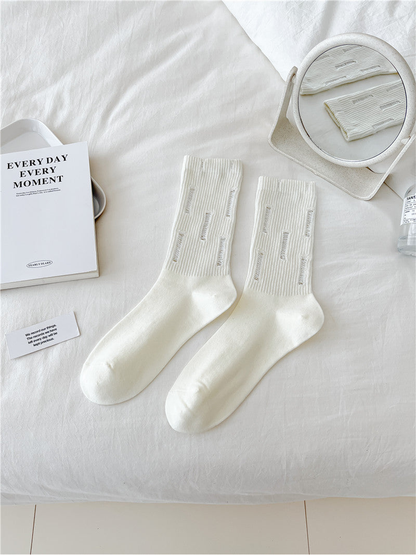 Ivory distressed ribbed crew socks, flat lay