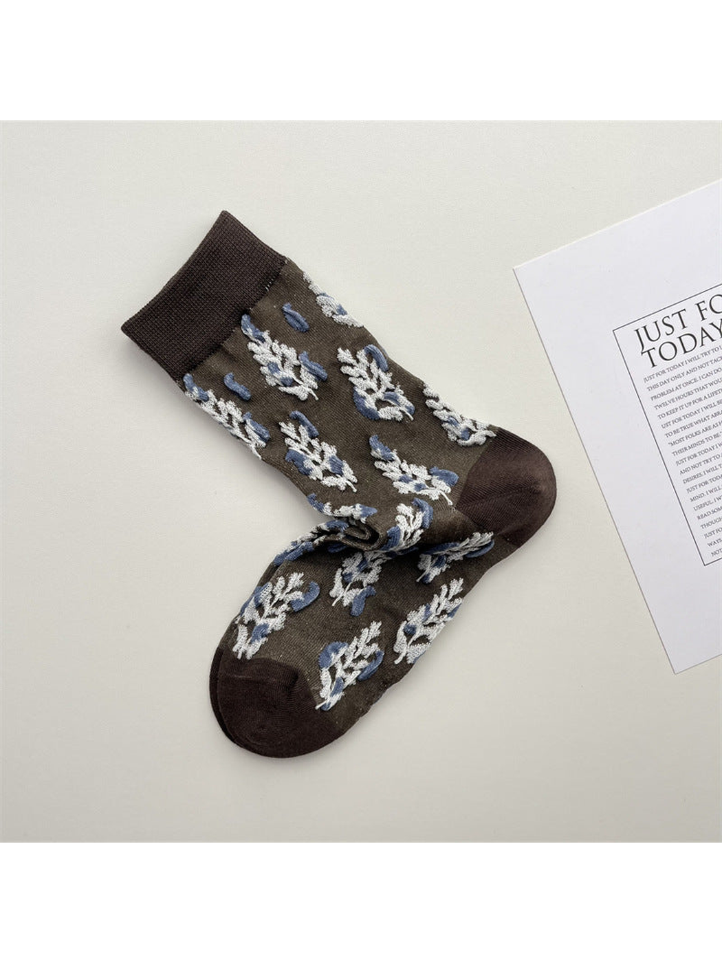 Gray crew socks with blue and white botanical sprig motifs
