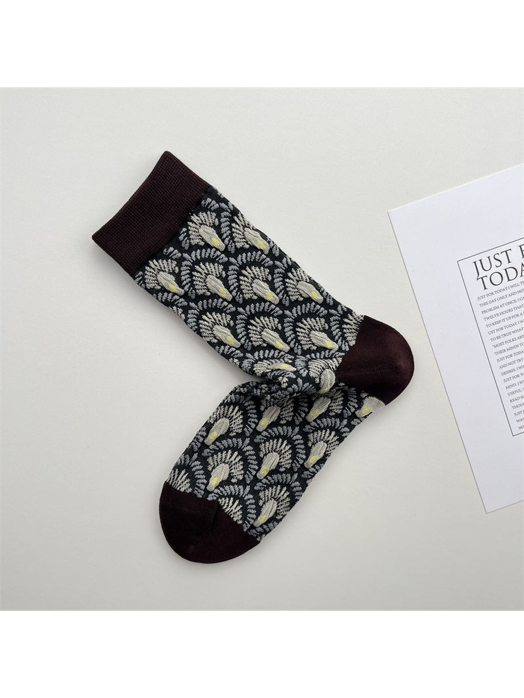 Black crew socks with raised fan motifs and dark brown trim