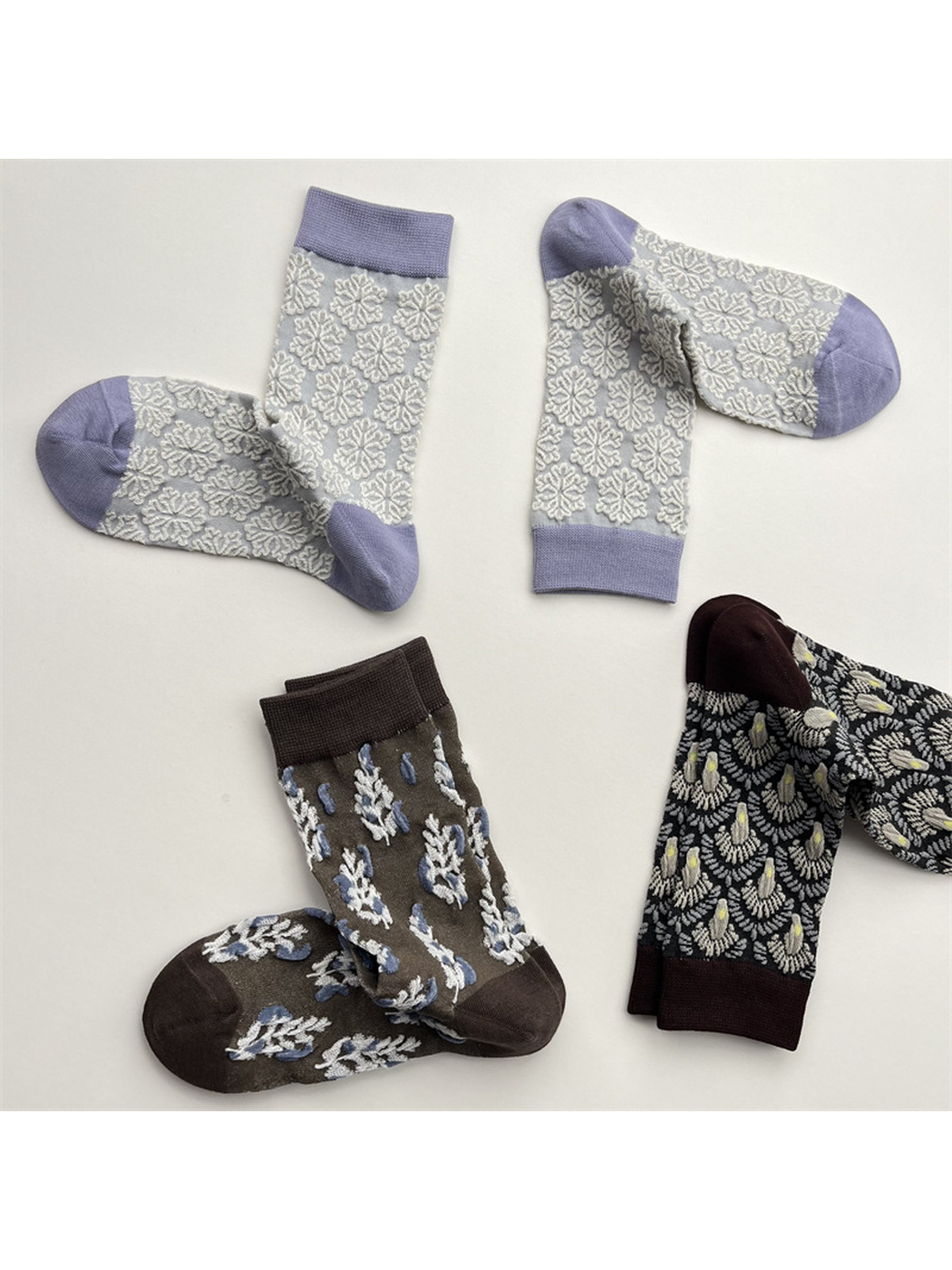 Three patterned crew sock designs arranged in a spaced flat lay
