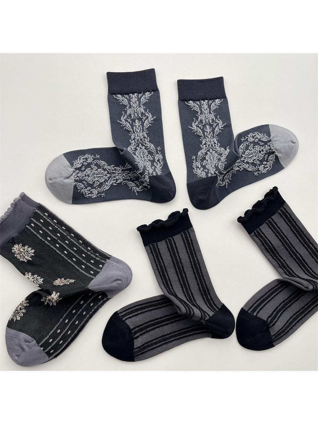 Three dark gray crew sock patterns displayed in paired arrangements