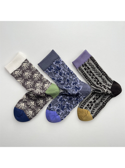 Three patterned crew sock styles arranged in an overlapping flat lay