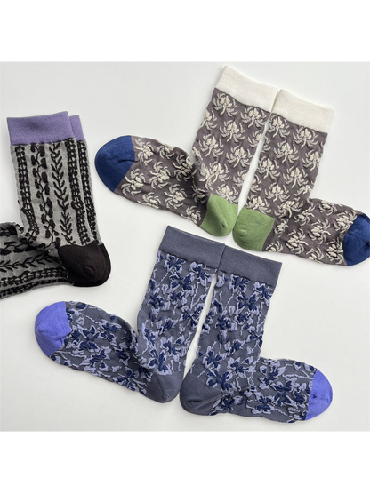 Three patterned crew sock styles in a close flat lay showing contrasting cuffs and toes