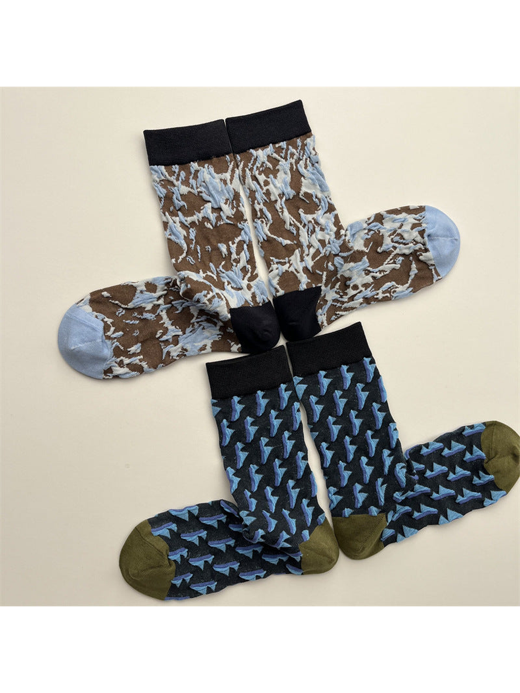 Brown marbled and navy triangle crew socks arranged in matching pairs