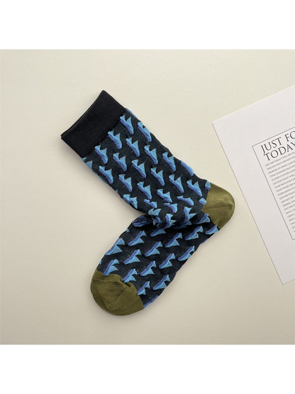 Navy crew socks with repeating blue triangle motifs and olive toes