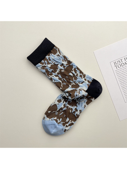 Brown crew socks with raised pale blue marbled motifs