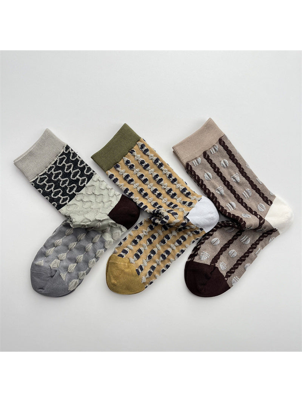 Three geometric crew sock designs arranged together