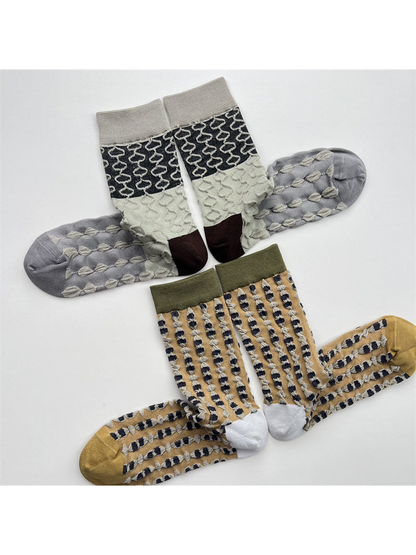 Mustard and color-block geometric crew socks displayed in pairs