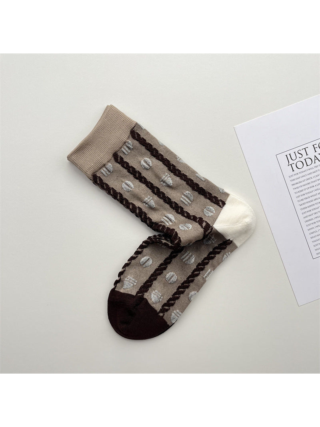 Khaki crew socks with brown braided stripes and raised dots
