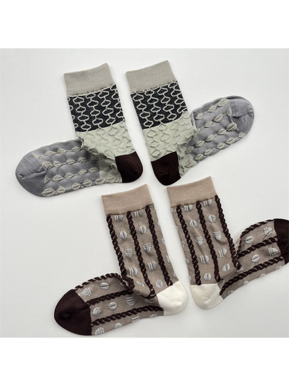 Khaki and color-block geometric crew socks displayed in pairs