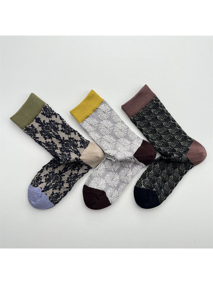 Three patterned crew sock designs arranged together on a light background