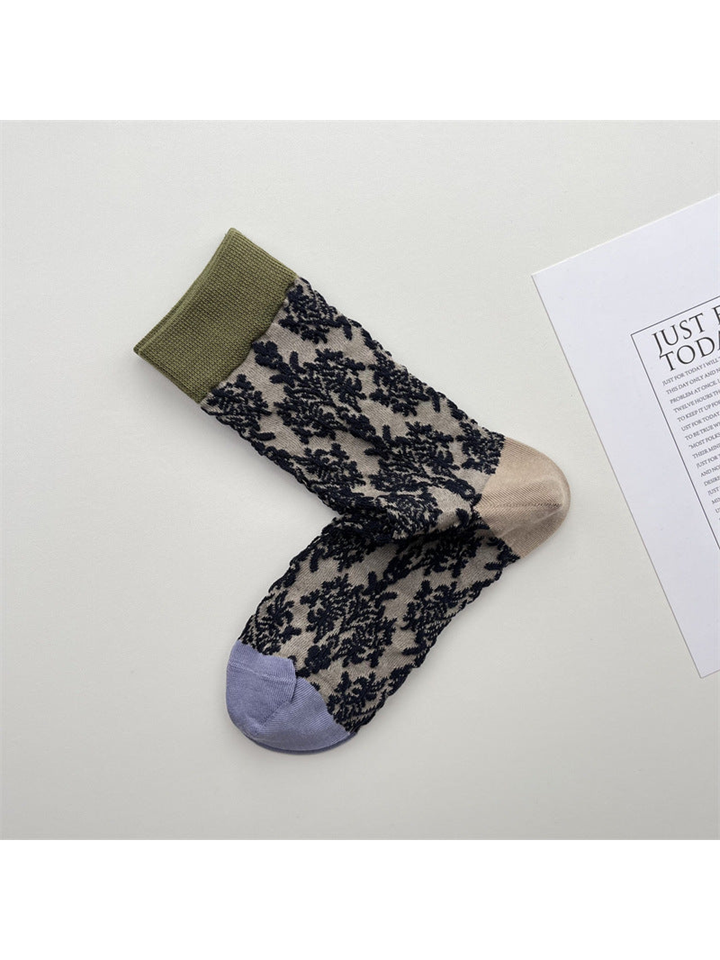 Beige sheer crew socks with dark floral pattern, olive cuffs and contrasting toes