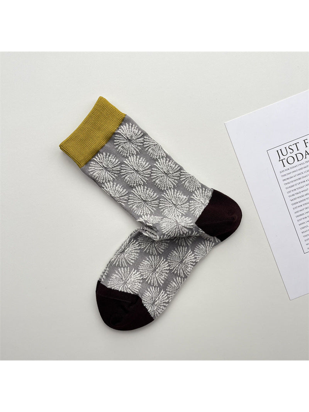 Light gray sheer crew socks with white dandelion pattern and mustard cuffs