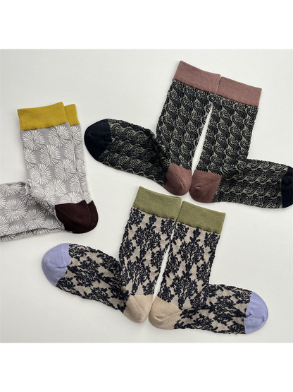 Three patterned crew sock designs arranged in paired flat-lay views