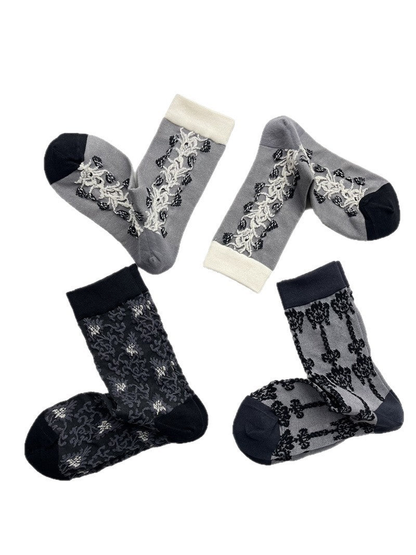 Three gray semi-sheer patterned crew sock designs displayed together