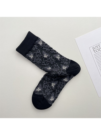 Dark gray crew socks with scattered floral pattern and black trim