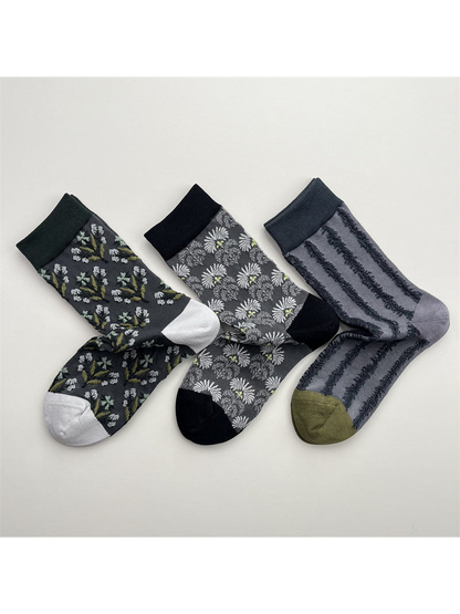 Three patterned crew sock styles displayed together