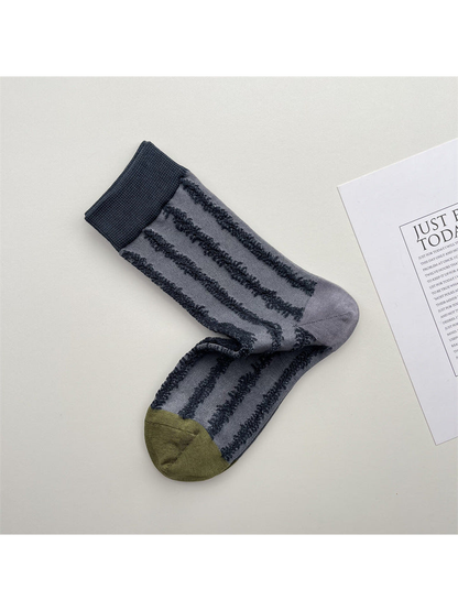 Blue-gray crew socks with raised dark stripes and olive toe