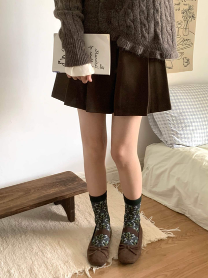 Floral crew socks styled with brown flats and a pleated skirt