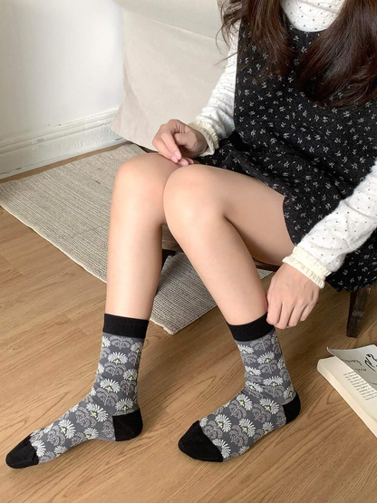 Daisy-pattern crew socks shown in a close seated view