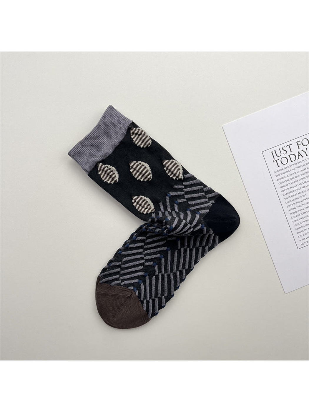 Black and gray crew socks with oval dots and diagonal stripe pattern