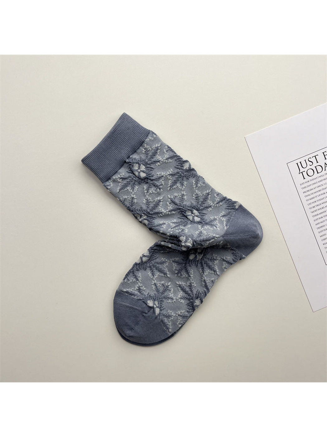 Blue-gray crew socks with pale floral branch pattern