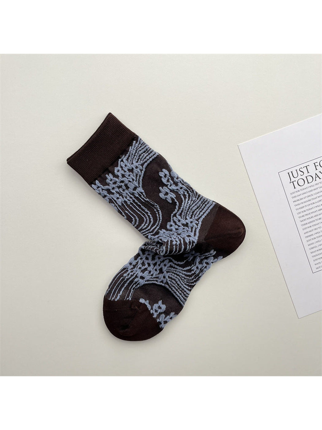 Dark brown crew socks with light blue wave and floral pattern