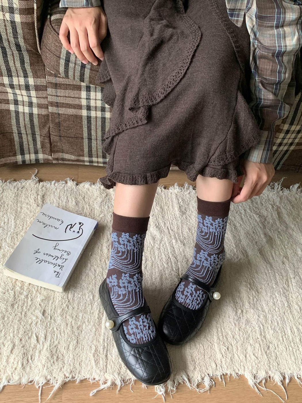 Dark brown and light blue patterned crew socks styled with black shoes