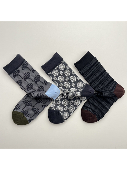 Three patterned crew sock styles displayed together