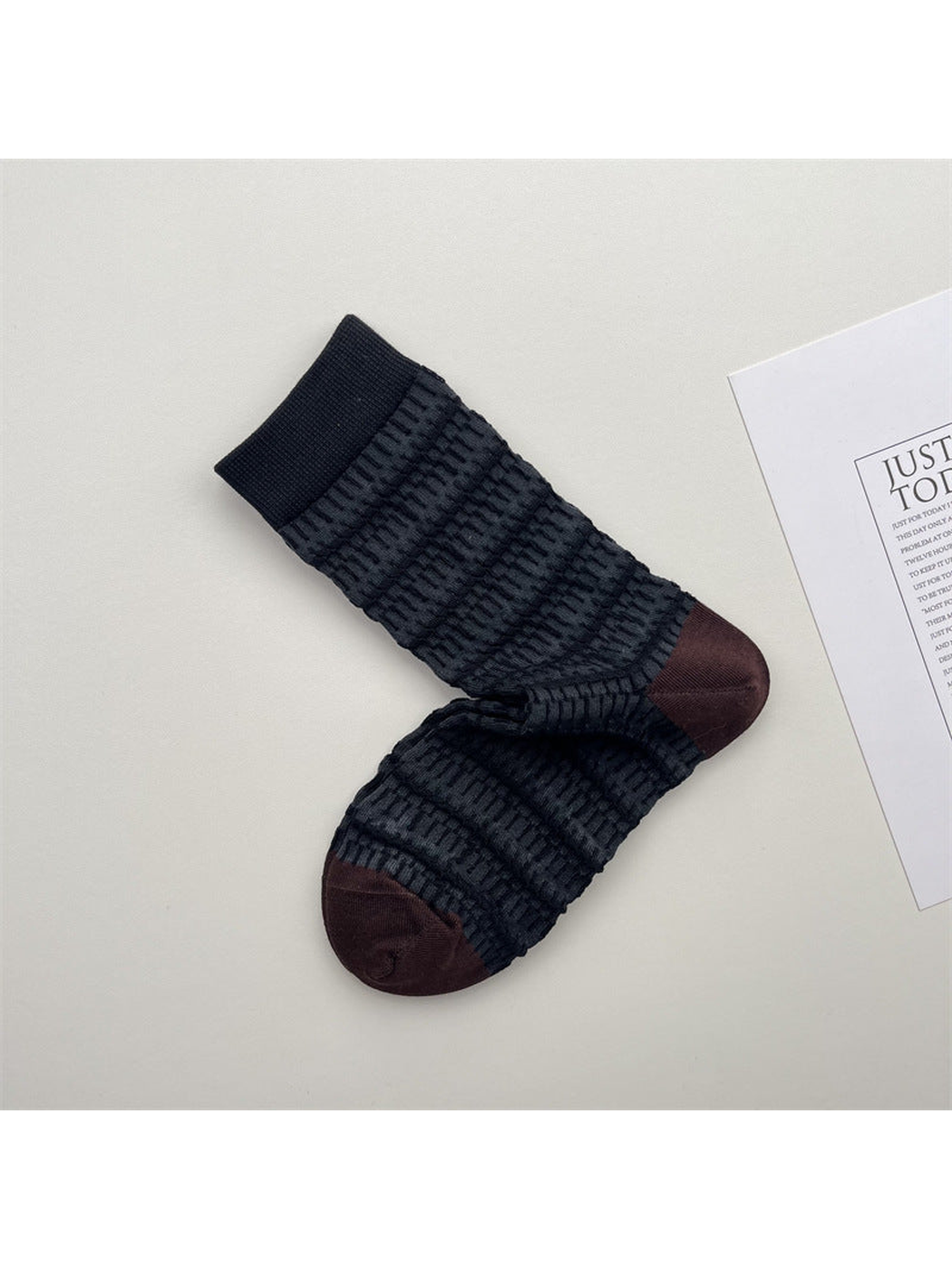 Dark striped crew socks with raised texture and brown toes
