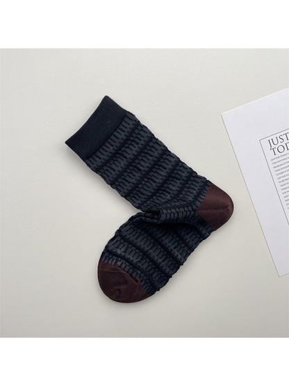 Dark striped crew socks with raised texture and brown toes