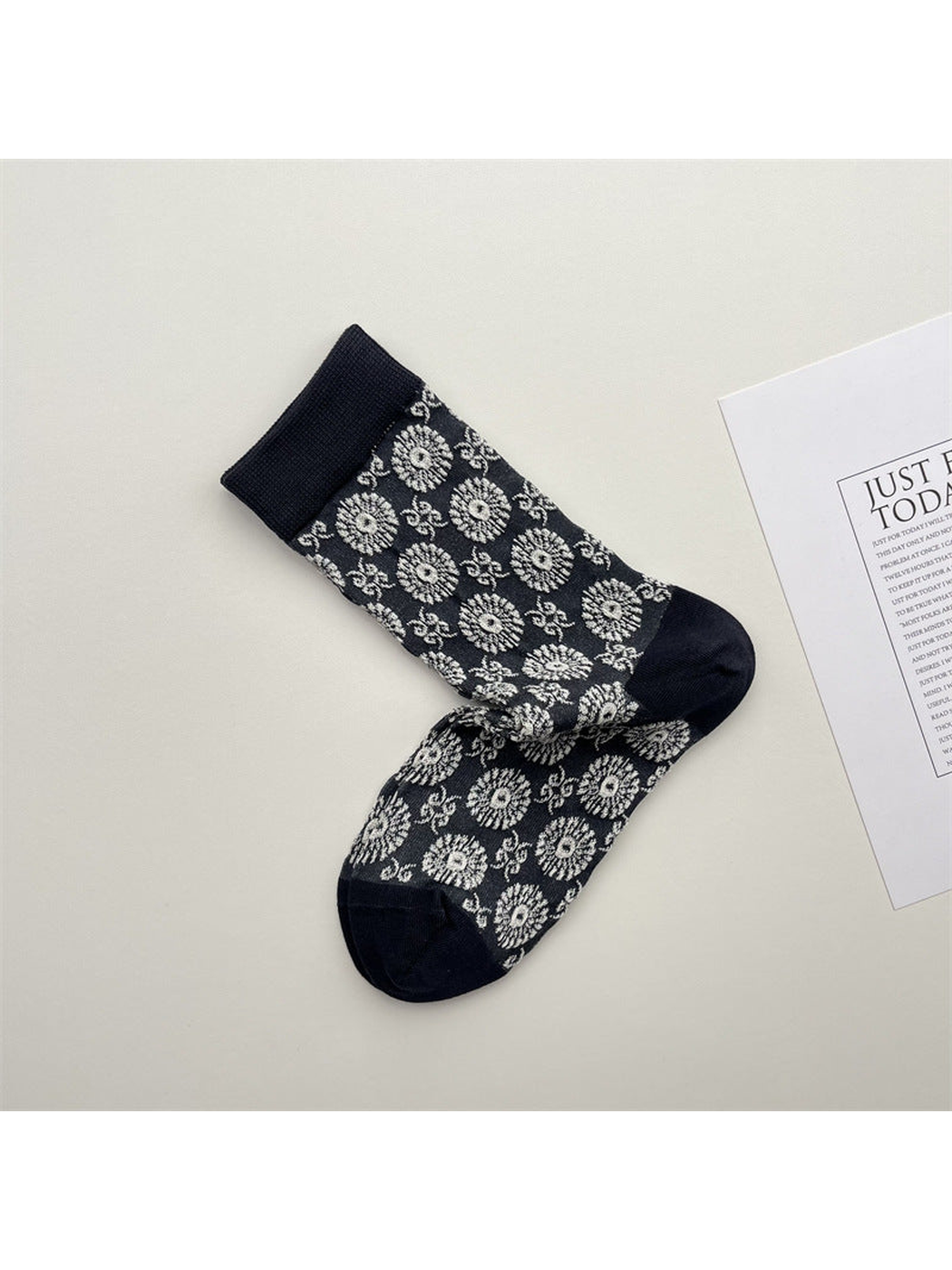 Dark crew socks with white floral medallion pattern