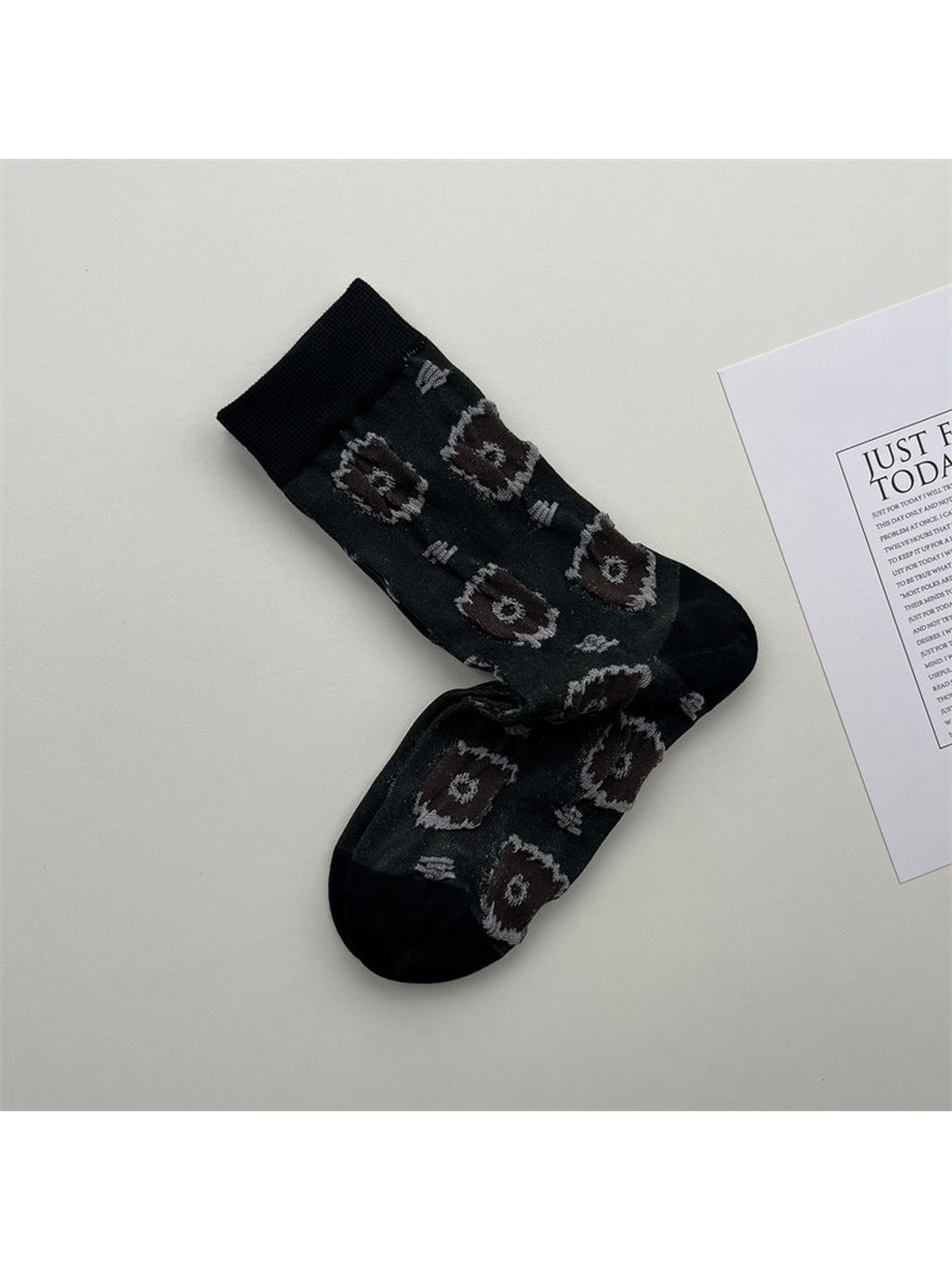Dark gray crew socks with repeating brown circular medallions