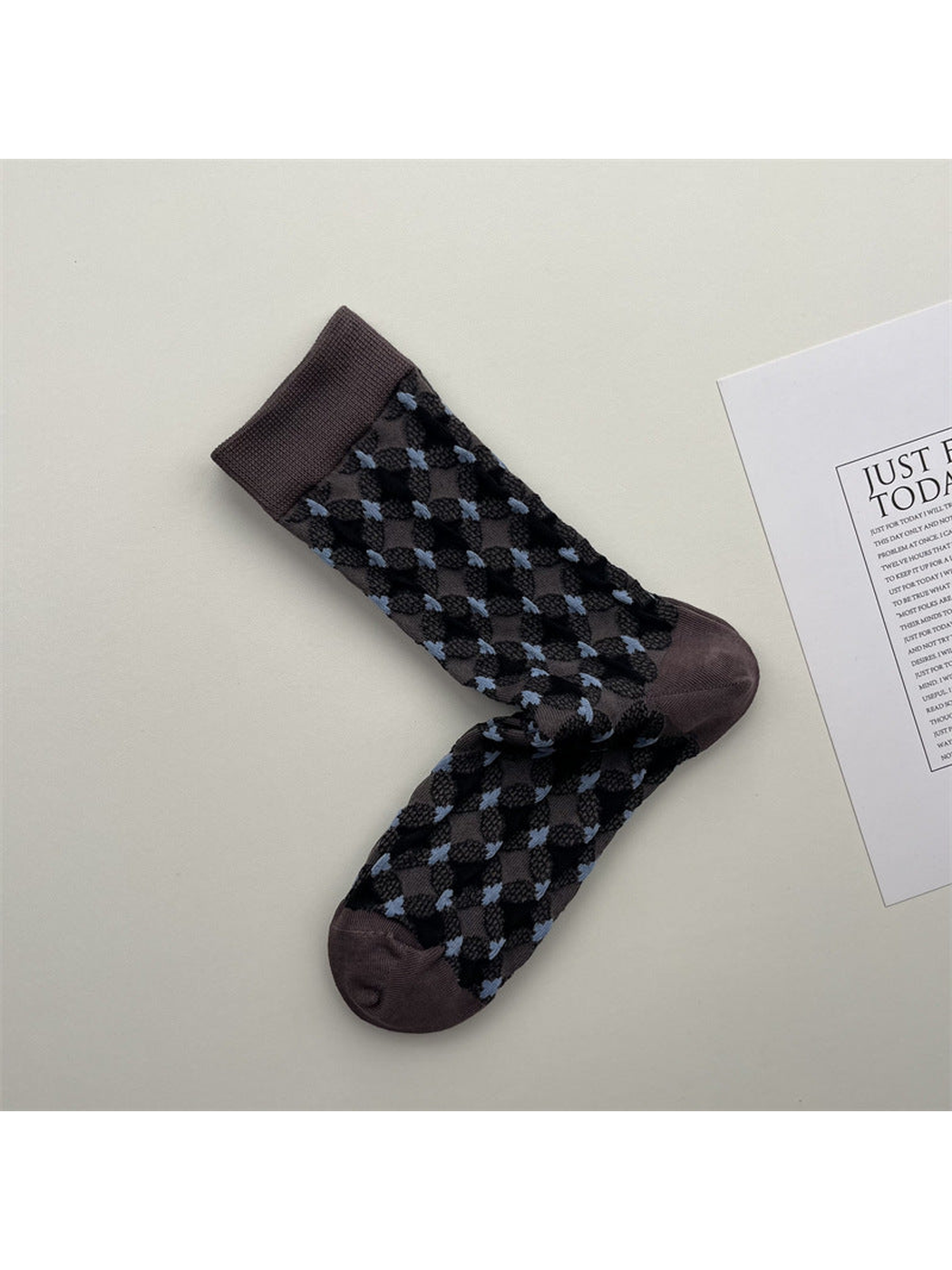 Muted purple crew socks with black diamonds and light blue accents