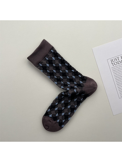 Muted purple crew socks with black diamonds and light blue accents
